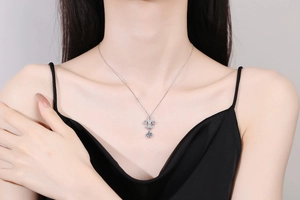 Close-up of s925 silver fleur-de-lis crown necklace with moissanite on a model