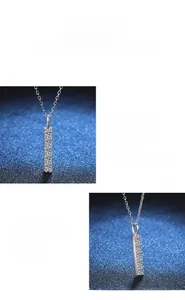 Macro shot of vertical pendant with sparkling moissanite diamonds on silver necklace