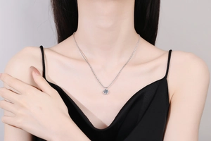 Detail of s925 silver crown necklace with a brilliant 1 carat moissanite on a model