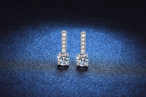 Detail of S925 sterling silver drop earrings featuring 1 carat moissanite and small diamonds