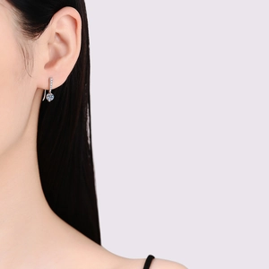 Elegant s925 silver moissanite drop earrings on a model showing a minimalist tear design