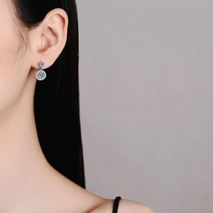 Elegant S925 sterling silver halo moissanite drop earrings worn by a model in close-up