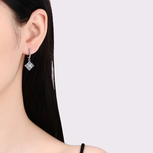 Elegant S925 sterling silver drop earrings with blue and clear moissanite on a model