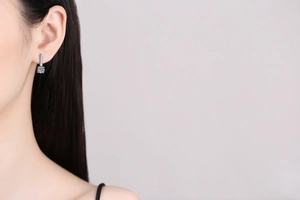Detailed view of S925 silver earring with vertical diamond bar and 1 carat moissanite stud