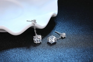 Macro detail of S925 sterling silver tassel earrings with four-prong set moissanite stones