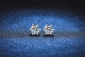 Close-up of S925 silver six-prong flower shape stud earrings with brilliant D-color moissanite