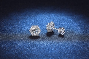 Macro detail of hexagonal snowflake stud earrings with sparkling D-color moissanite stones