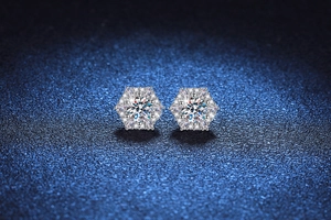 Macro detail of hexagonal snowflake stud earrings with round moissanite and pave setting