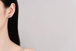 Detail of 925 sterling silver moissanite stud earring worn on the earlobe