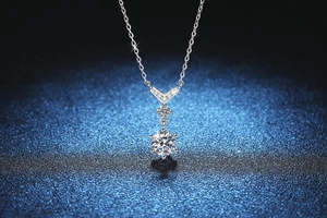 Detailed view of the S925 sterling silver fishtail pendant with moissanite center stone