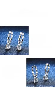 Detail of beaded hoop earrings featuring six-prong set round brilliant cut moissanite stones
