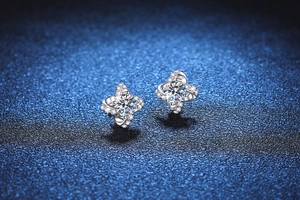 Macro shot of s925 silver clover earrings featuring moissanite with four-prong setting