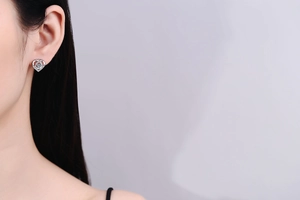 Close-up of heart-shaped S925 sterling silver moissanite stud earring on ear