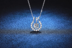 Macro shot of S925 sterling silver necklace with halo moissanite pendant on blue texture