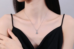 Elegant S925 silver snowflake necklace with Moissanite stone worn on a model's neck