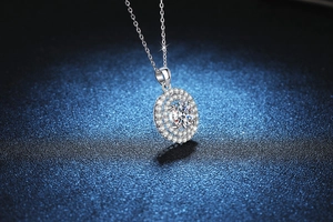 Macro shot of 2 carat Moissanite pendant with double halo setting on silver chain