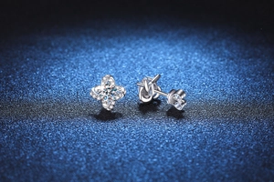 Macro view of S925 silver clover earrings with a central moissanite diamond and pavé accents