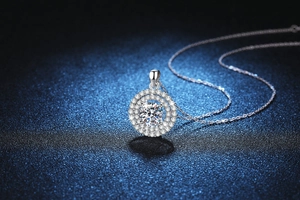 Macro shot of 2ct Moissanite pendant featuring double halo setting and silver cable chain