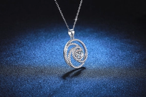 Macro shot of silver three-layer spiral pendant with brilliant moissanite and micro-pave