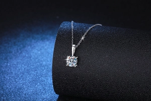 Detail view of 1 carat Moissanite pendant with four-prong setting and silver chain