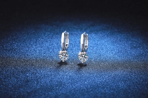 Macro shot of 925 silver stud earrings with 1 carat moissanite in a four-prong setting