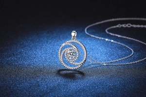 Macro shot of S925 sterling silver windmill pendant necklace with sparkling Moissanite stones