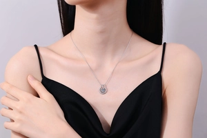 Detail of S925 silver horseshoe pendant with moissanite on a model's neck