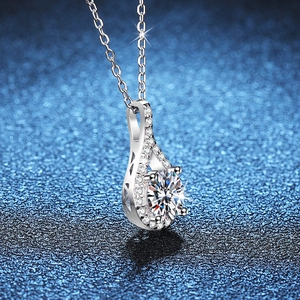 S925 sterling silver necklace with teardrop moissanite pendant on navy starry background