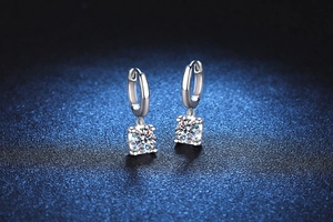 Macro detail of S925 sterling silver moissanite drop earrings with classic four-prong setting