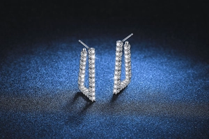 Detailed side view of S925 silver U-shape earrings with twisted texture and pavé set stones