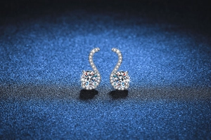 Macro detail of S925 sterling silver S-shaped earrings with one carat moissanite stones