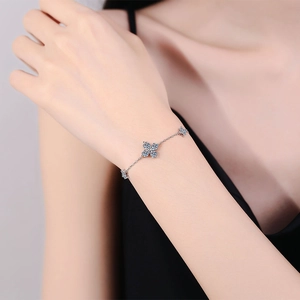 Elegant S925 silver bracelet featuring blue clover pendants with brilliant moissanite stones