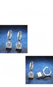 Detail of polished S925 silver earrings featuring four-prong moissanite setting