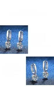 Detail view of polished S925 silver hoop earrings with a sparkling Moissanite pendant