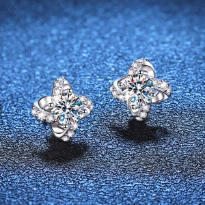 S925 sterling silver four-leaf clover moissanite stud earrings on a starry blue background