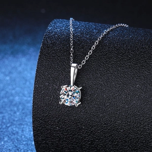 Elegant S925 sterling silver necklace with a 1ct round moissanite pendant on black stand