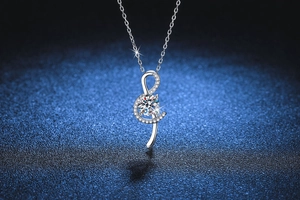 Close-up of S925 silver musical note pendant with sparkling round cut moissanite stone