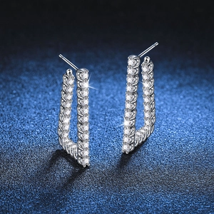 L-shaped S925 sterling silver hoop earrings with pavé moissanite stones on dark surface