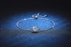 Detailed view of S925 silver bracelet featuring a four-prong Moissanite and bolo clasp