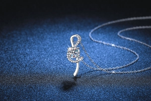 Macro view of S925 silver treble clef necklace featuring a 1-carat moissanite stone