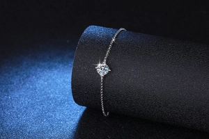 Detailed shot of the 1ct Moissanite center stone in a classic 4-prong silver setting