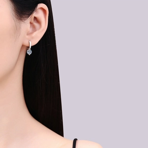Elegant S925 sterling silver hoop earrings with a sparkling round moissanite on model