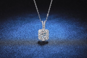 Macro shot of 925 silver flower pendant with sparkling oval cut moissanite and halo