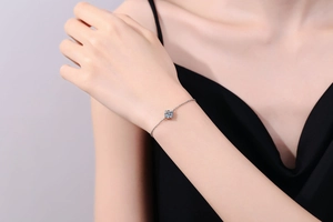 Detailed view of an S925 silver bracelet featuring a four-claw set Moissanite on a wrist