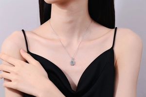 Detailed view of an S925 sterling silver necklace with a 1ct Moissanite pendant on a model