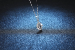 Macro detail of S925 sterling silver necklace with marquise cut moissanite halo pendant