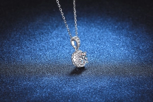 Macro view of 925 silver necklace featuring moissanite halo pendant and side filigree