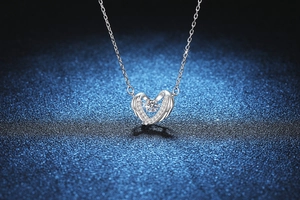 Detailed view of S925 silver angel wing necklace with a dancing moissanite stone