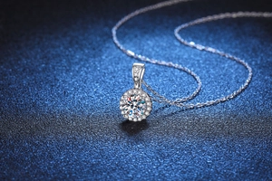 Macro shot of a halo-set round moissanite pendant with a classic S925 silver link chain