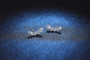 Macro shot of curved S925 silver earrings with five gradient moissanite stones